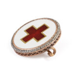 side view of enamel and diamond red cross brooch