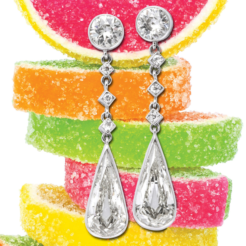 antique diamond tear drop earrings behind stacked candy fruit slices