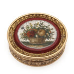 Gold oval box with purpurine center set with micromosaic floral design