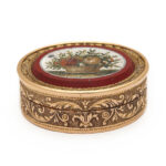 front view of oval gold and micromosaic box
