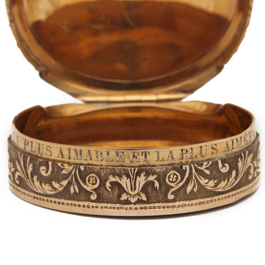 rim detail with inscription on oval gold box