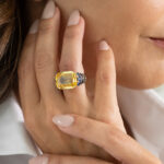 Model hand shot of yellow and blue sapphire ring