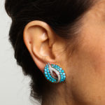 Model wearing 1950s Turquoise and Diamond Clip Earrings by Cartier