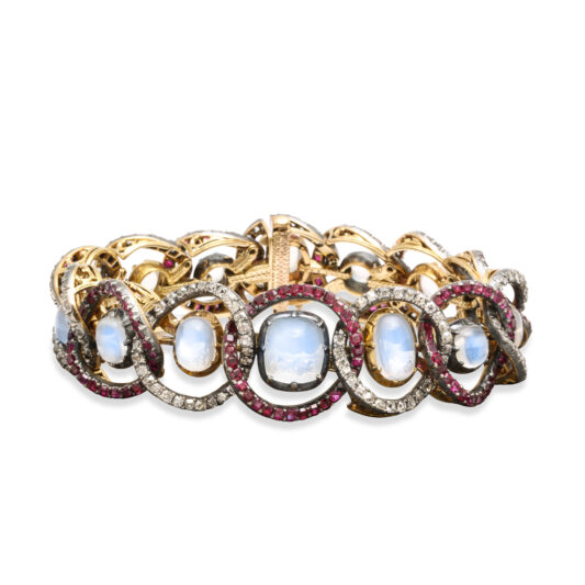 antique bracelet with cabochon moonstone set within interlocked rings, alternatingly set with diamonds and rubies.
