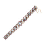 lengthwise view of antique cabochon moonstone bracelet set within ruby and diamond interlocked rings