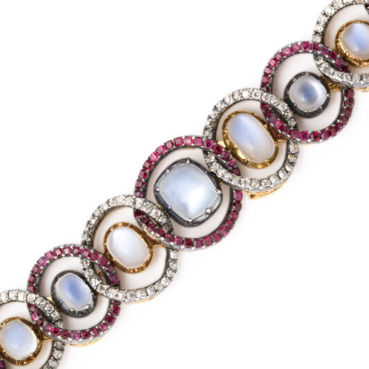 detail view of moonstone bracelet set with interlocking ruby and diamond rings