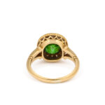 back view of antique gold mounted green garnet ring encircled by diamonds