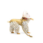 Profile view of gold and pearl poodle pendant