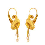 gold Etruscan revival earrings of a trumpet flower design with pearl drops coming from the center