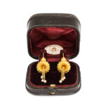 view of gold Etruscan revival earrings in original retail box