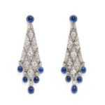 Diamond lozenge shaped pendant earrings set with cabochon sapphires at the top and bottom, front view