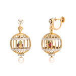 front and side view of gold and diamond spherical bird cage earrings, each containing a ruby and emerald parrot.
