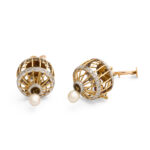bottom view of gold and diamond bird cage earrings with pearl drops