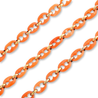 detail view of gold and carved coral mariner link chain necklace
