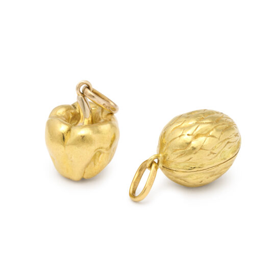 two gold pendants in the form of a pepper and a walnut