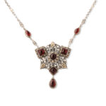 front view of silver and gold Arts and Crafts pendant set with cabochon garnets