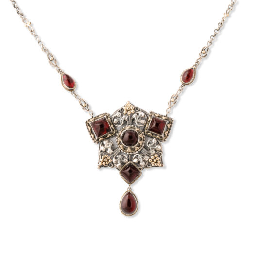 front view of silver and gold Arts and Crafts pendant set with cabochon garnets