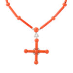 Front view of coral and diamond cross necklace