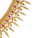 detail view of gold fringe necklace with acorns, rubies, and natural pearls