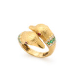 other view of 1960s gold ring style as two embracing ducks with ruby eyes, set with diamonds end emeralds