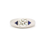 top view of platinum man's ring set with diamond and triangular sapphire shoulders