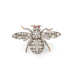 top view of diamond bumble bee brooch with ruby eyes