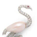 detail view of Mississippi river pearl, diamond, and ruby flamingo brooch
