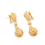 side view of gold and multicolor diamond earrings
