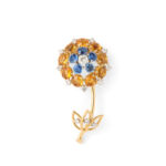 main view of antique Cartier floral brooch designed with citrines, sapphires, and diamonds on a gold stem with diamond-set leaves