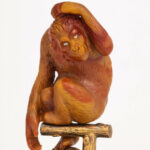 Close up view of Faberge jasper sculpture of a monkey with diamond eyes sitting on a gilded perch