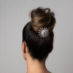 Back of model's head wearing diamond sunburst hair ornament