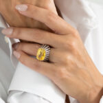 detail hand shot of yellow sapphire and diamond ring