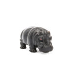 FabergÃ© carved obsidian sculpture of a hippo with ruby eyes, facing right