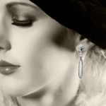 Model wearing diamond and onyx pendant earrings by Marcus & Co