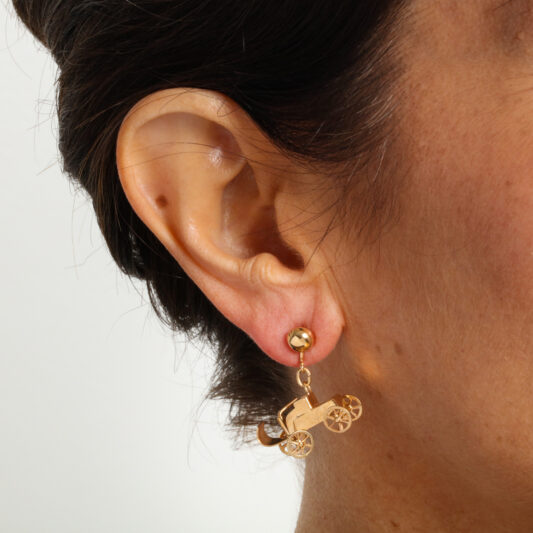 Model wearing antique gold automobile earrings